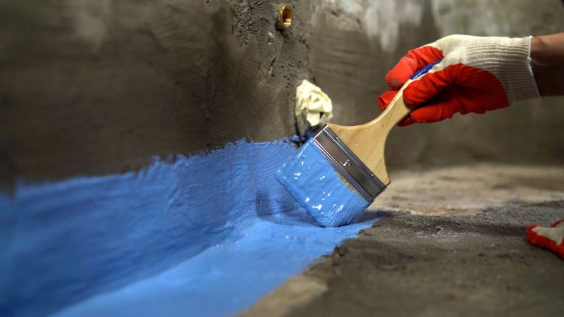 Contractor Applying Waterproof Coating